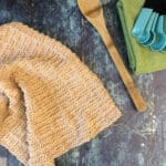 Textured towel in beige with wooden spoon.