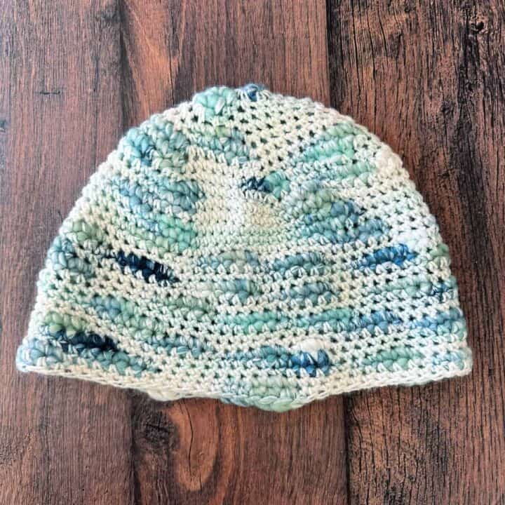Crochet hat in blue white chunky yarn.